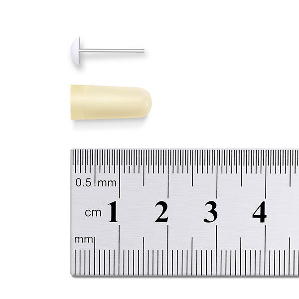 Osmotic pump parts being measured with a ruler