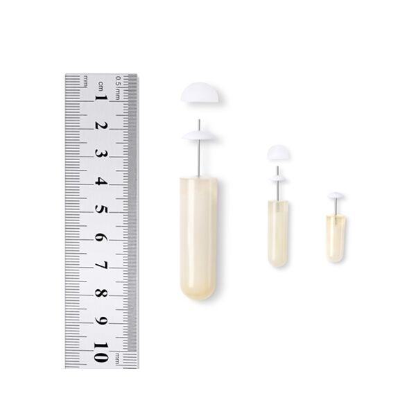 Osmotic pump parts displayed next to a ruler